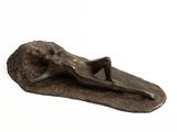 bronze sculpture of a woman laying on a leaf