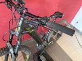a close up of a bicycle parked in front of a red wall
