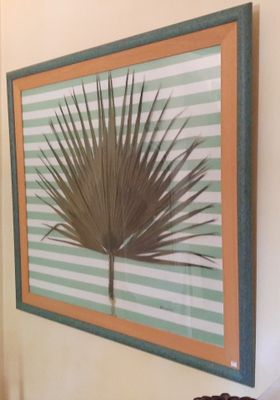 a picture of a picture of a palm tree hanging on the wall
