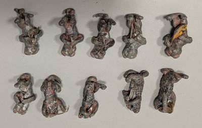 many figurines of different shapes and sizes on a white surface