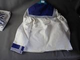 a white jacket with a blue sailor ' s collar on a bed