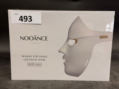 a box with a white mask on it on a table