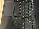 a close up of a laptop keyboard on a wooden table