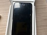 someone is holding a box with a phone inside of it on a table