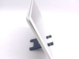 a white tablet computer sitting on top of a stand
