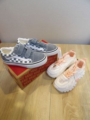 two pairs of shoes are sitting on a box on a table