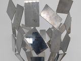 a metal sculpture that has many pieces of metal in it
