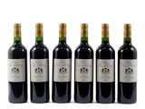 six bottles of wine are lined up on a white surface