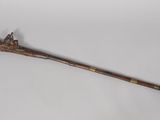 a wooden stick with a long handle on a white surface