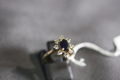 a ring with a sapphire and diamonds on it on a table