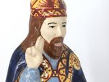 a figurine of a man with a crown on his head