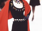 a woman that is walking down the runway wearing a hat