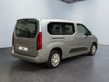 the silver van is parked in the empty room of the building