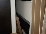 a refrigerator and a microwave in a room with a lot of boxes