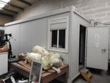 a small room with a lot of stuff on the table