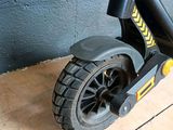 a scooter that is sitting on the floor in front of a wall
