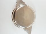 an overhead view of a silver plate on a white surface