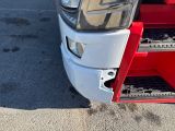 a close up of the front of a red and white truck