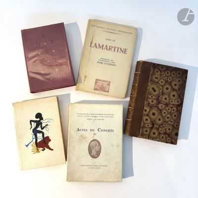 several old books sitting on top of a white table next to each other