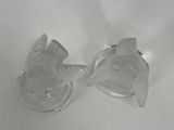 two clear glass vases sitting on top of a white table