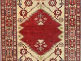 a red and beige rug with a diamond design on it