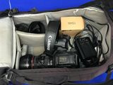a bag with a camera and other electronics inside of it