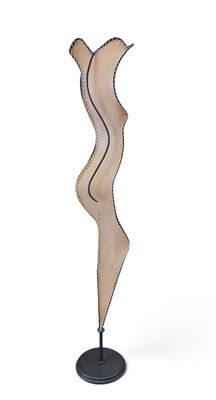 a close up of a wooden sculpture on a black stand