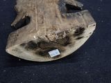 a piece of wood with a tag on it