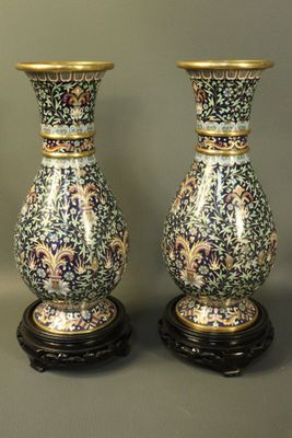 three vases are sitting on a table with a gray background
