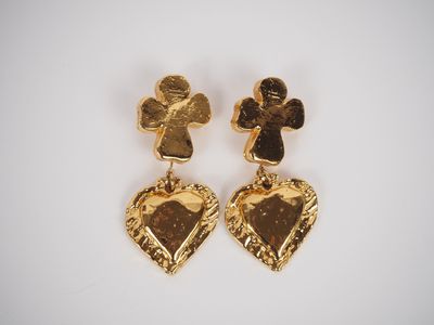 a pair of gold toned heart shaped earrings with an angel and cross