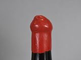 a close up of a red lipstick with a black tip