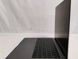 an open laptop computer sitting on top of a white surface