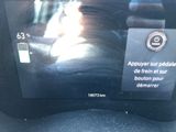 a picture of a car ' s dashboard with a picture of a cat on it