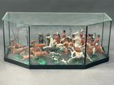 a glass display case with figurines of people and animals in it
