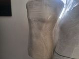 two mannequins wrapped in plastic in a room