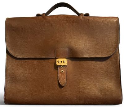 a brown briefcase sitting on top of a white surface