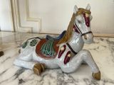 a white horse that is sitting on a marble table