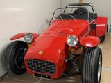 a red sports car parked in a garage next to a wall