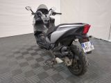 a motorcycle that is parked in a room with a checkered floor