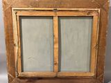 an old wooden window with two glass panes and a wooden frame