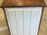 a wooden cabinet with a wooden top on the floor