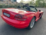 a red sports car parked in a parking lot