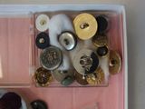 a box of buttons and buttons on a table