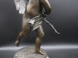 an image of a statue of a cupid holding a bow and arrow