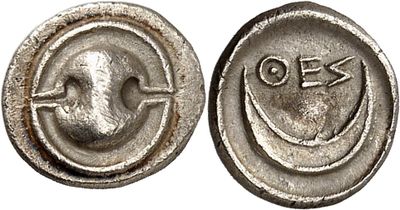a close up of a coin with a smiley face on it