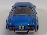 a blue toy car that is sitting on a white surface