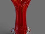 un vase en verre rouge posé sur une table