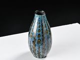a blue vase that is sitting on a white table