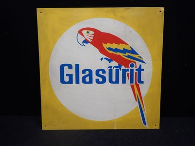 une pancarte sur laquelle est écrit « Glastrit » et sur laquelle figure un perroquet