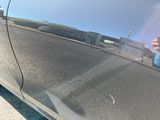 a reflection of a person on the side of a car